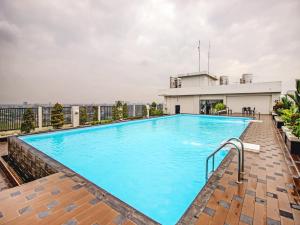 a large swimming pool on the roof of a building at Super OYO 90245 Tridasa in Medan