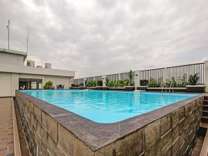 a swimming pool on the roof of a building at Super OYO 90245 Tridasa in Medan