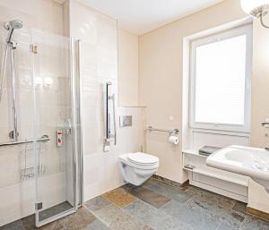 e bagno con servizi igienici, lavandino e doccia. di Johannishof Wein-Café & Gästehaus a Mesenich