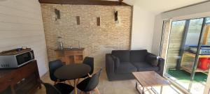 a living room with a couch and a table at Appartement Ychoux in Ychoux