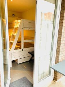 a closet with wooden shelves in a room at Even Aan Zee - Dukdalf in Nieuwpoort