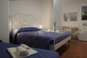 a bedroom with two beds with towels on them at AGRITURISMO CASA RICOTTA in Metaponto