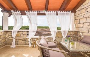 a patio with a table and chairs and a window at Villa Kluni in Momjan