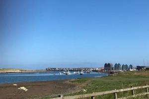 a view of a river with boats in it at On The Harbour - unrivalled views of Amble's harbour and estuary in Amble