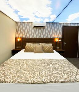 una camera da letto con un letto e un dipinto sul soffitto di Emily Rose Hotel a Kemer