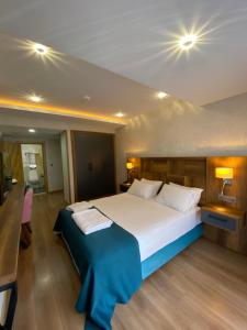 a bedroom with a large bed with two pillows at Dedehan Hotel in Trabzon