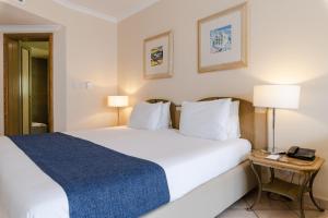 a hotel room with a bed and a telephone at Maritim Antonine Hotel & Spa in Mellieħa