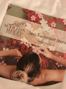 a magazine with a picture of a woman in a spa treatment room at Maritim Antonine Hotel & Spa in Mellieħa