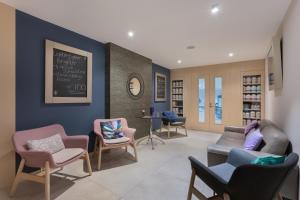 a waiting room with chairs and a chalkboard on the wall at Maritim Antonine Hotel & Spa in Mellieħa
