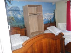 Châlus的住宿－l'escale gourmande，一间卧室设有两张床,墙上挂着一幅画