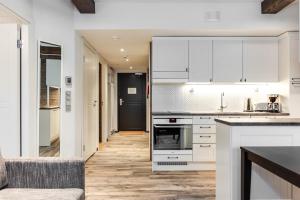 a kitchen with white cabinets and a counter top at RukaValley Unique58 in Ruka