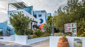 a blue and white house with a barrel at Villa Kalliopi in Koutsounari