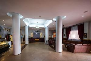 a lobby with columns and a couch in a building at Angkor International Hotel in Phnom Penh