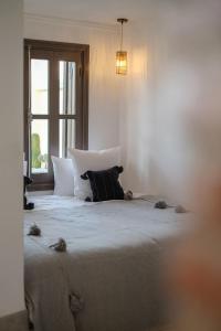 una camera da letto con un grande letto con un cuscino sopra di Riad O a Marrakech