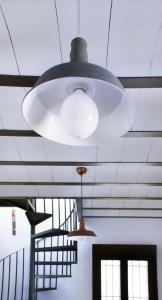 a large white light hanging from a ceiling at El Loft de Dulcinea: en el corazón de El Toboso. in El Toboso