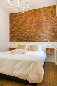 1 dormitorio con pared de ladrillo y 2 camas en Modern apartment, self check-in, Wi-Fi, Smart TV 55" 4K, en Madrid