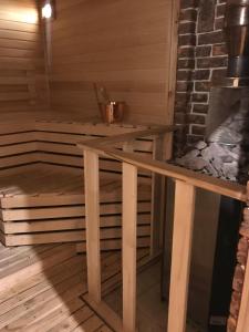 a sauna with a wooden table in a room at Клёвое место in Protsev