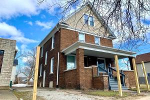 a brick house with a gambrel roof at The Hennepin House- With Private Yard & Parking, Minutes From Falls & Casino by Niagara Hospitality in Niagara Falls