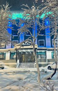 a building with snow covered trees in front of it at Severnaya in Kirovsk