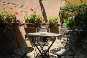 a patio table and chairs with flowers and plants at Art Hotel Al Fagiano in Padova
