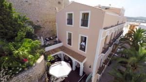 an aerial view of a building with a boat in front at Mirador de Dalt Vila-Relais & Chateaux in Ibiza Town