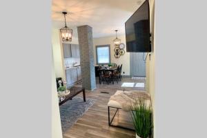 a living room with a kitchen and a dining room at The Southside Villa- With Private Yard & Free Parking, Minutes From Falls & Casino by Niagara Hospitality in Niagara Falls