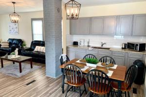 a kitchen and living room with a table and chairs at The Southside Villa- With Private Yard & Free Parking, Minutes From Falls & Casino by Niagara Hospitality in Niagara Falls
