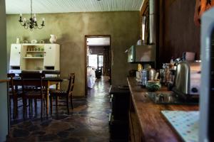 a kitchen with a table and a dining room at Honey Farm Country Get Away in Skeerpoort