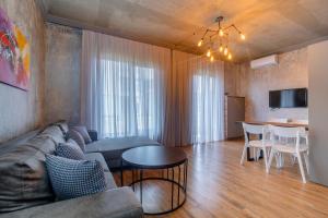 a living room with a couch and a table at Magnetic Resort Ureki in Ureki