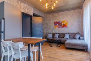 a living room with a couch and a table at Magnetic Resort Ureki in Ureki