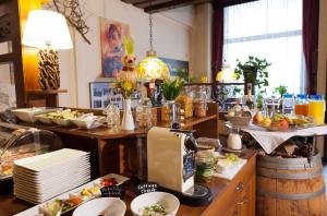 a kitchen with a table with food on it at Pension Frühwirth in Bad Tatzmannsdorf