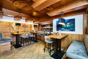 um restaurante com paredes e mesas de madeira e bancos em Hotel Rupertihof em Ainring