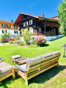 a wooden bench sitting in front of a house at Chalet Jungfrau View in Interlaken