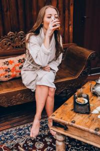 a woman sitting on a bench eating food on a table at L'écrin de Rûmi in Vaires-sur-Marne +38 photos