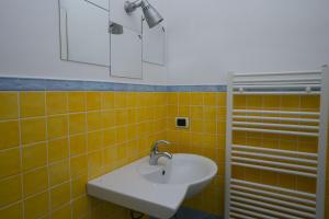 une salle de bain avec un lavabo et un miroir dans l'établissement N006 - Numana, nuovo bilocale nel cuore del paese, à Numana