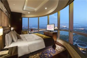 Crowne Plaza Zhangzhou, an IHG Hotel في Zhangzhou: غرفة نوم بسرير كبير ونافذة كبيرة