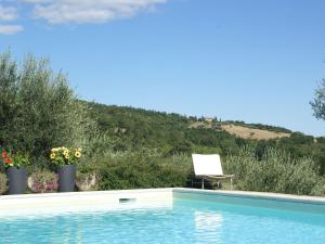 uma piscina com uma cadeira ao lado de uma montanha em Belvilla by OYO Villa San Donato em Galera