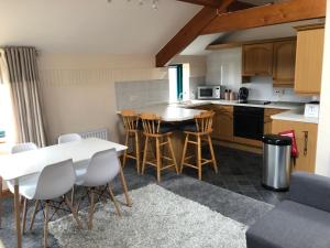a kitchen with a table and chairs in a room at Beacon View in Penrith