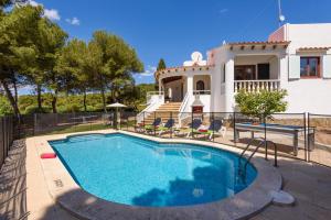a swimming pool in front of a house at Villa Amapola by Villa Plus in Santo Tomás