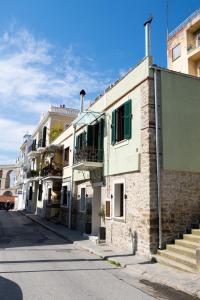 a brick building with a balcony on a street at Elia City House in Kavala