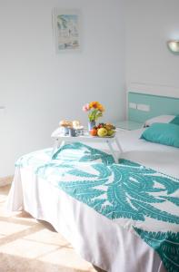 
a bedroom with a bed, a table, and a dresser at Hotel Blanca Brisa Cabo de Gata in El Cabo de Gata
