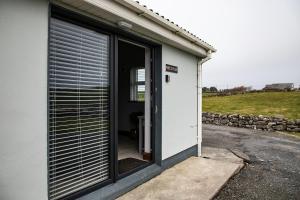 a door to a building with a garage at Noel's Place in Doolin