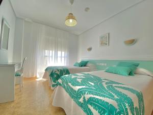 
a bed room with a white bedspread and a blue wall at Hotel Blanca Brisa Cabo de Gata in El Cabo de Gata
