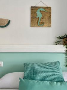 a bed with a green pillow in a room at Hotel Blanca Brisa Cabo de Gata in El Cabo de Gata