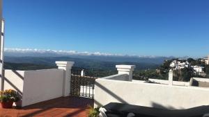 a white balcony with a view of the mountains at Casares Village Bed & Breakfast in Casares