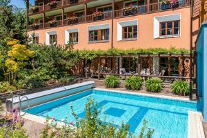 a hotel with a swimming pool in front of a building at Gasthof Löwen in Schruns