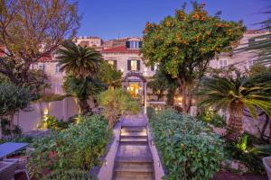 a garden with stairs in front of a building at Heritage Villa Nobile in Dubrovnik