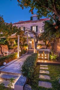 a house with a stone walkway in front of it at Heritage Villa Nobile in Dubrovnik