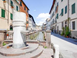 a street in a city with buildings and a bridge at Mansion in Lucca near Via Fillungo in Lucca