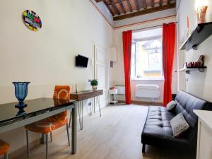 a living room with a couch and a table at Mansion in Lucca near Via Fillungo in Lucca